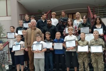 Children honored in Kyiv for helping clear rubble after Russian attack