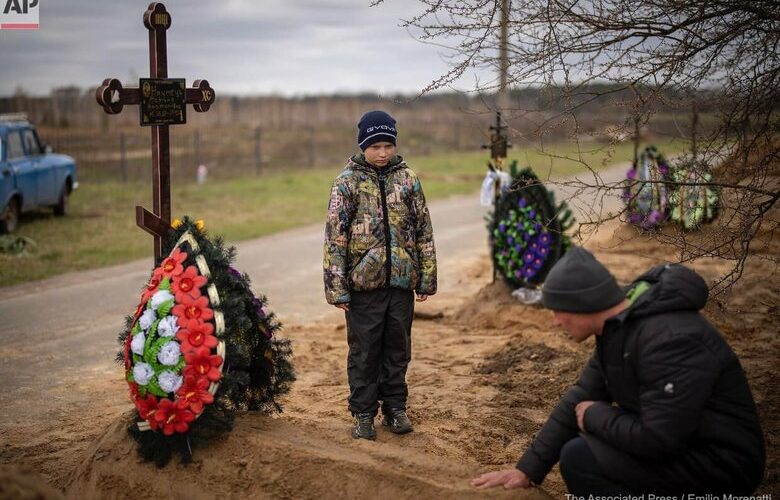 10-year-old Vova at funeral of his mother Marina, killed by Russian occupiers in Bucha. PHOTOS